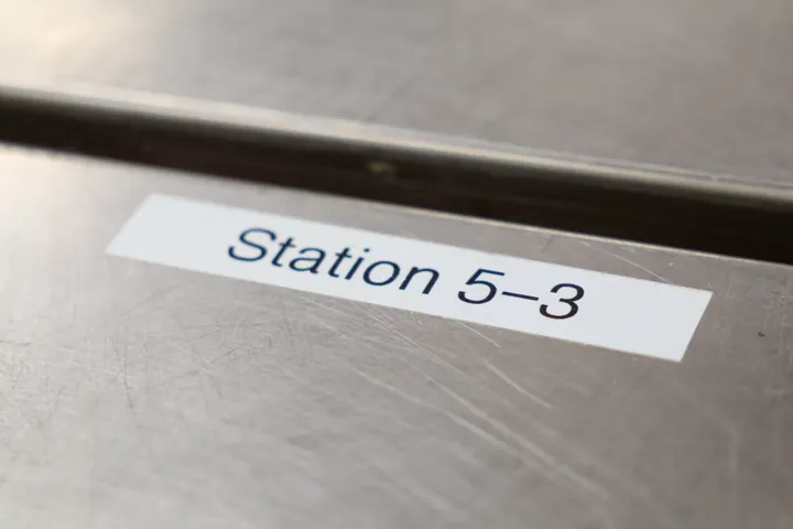 A label reading Station 5-3 on a stainless table